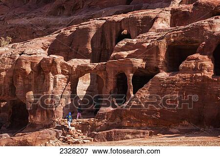 Stock Photo - Jordan, Tourists viewing ancient buildings; Petra. Fotosearch