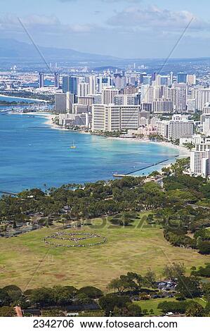 Stock Photograph - Kapiolani park and buildings along the coastline; Waikiki, Oahu, Hawaii, United States of America. Fotosearch
