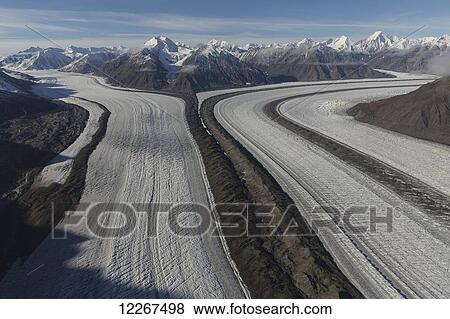 Kaskawalsh Glacier as it flows out of the St. Elias Icefields in Kluane National Park and Reserve; Yukon, Canada View Large Photo Image Stock Photo - Kaskawalsh Glacier as it flows out of the St. Elias Icefields in Kluane National Park and Reserve; Yukon, Canada. Fotosearch