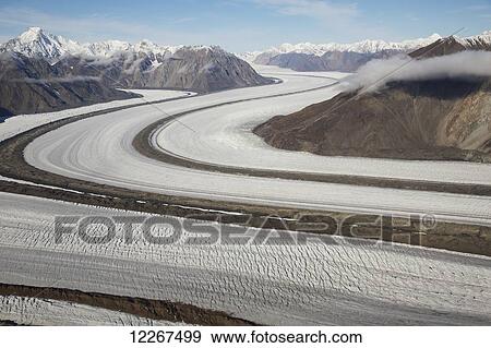 Kaskawalsh Glacier as it flows out of the St. Elias Icefields in Kluane National Park and Reserve; Yukon, Canada View Large Photo Image Stock Photo - Kaskawalsh Glacier as it flows out of the St. Elias Icefields in Kluane National Park and Reserve; Yukon, Canada. Fotosearch