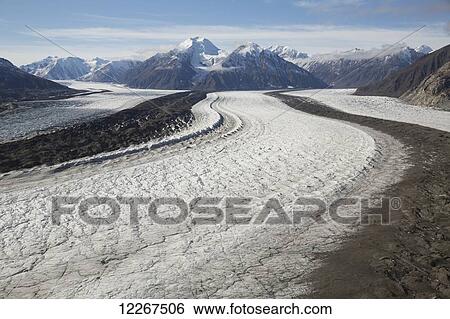 Kaskawalsh Glacier as it flows out of the St. Elias Icefields in Kluane National Park and Reserve; Yukon, Canada View Large Photo Image Stock Photograph - Kaskawalsh Glacier as it flows out of the St. Elias Icefields in Kluane National Park and Reserve; Yukon, Canada. Fotosearch