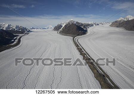 Kaskawalsh Glacier as it flows out of the St. Elias Icefields in Kluane National Park and Reserve; Yukon, Canada View Large Photo Image Stock Photography - Kaskawalsh Glacier as it flows out of the St. Elias Icefields in Kluane National Park and Reserve; Yukon, Canada. Fotosearch