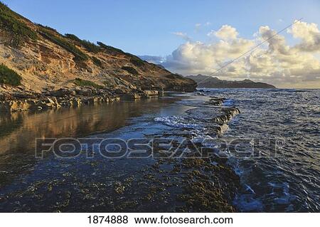 Stock Photo - Kauai, Hawaii, United States Of America; Wave-Washed Flat Reef At The Base Of The Makewehi Cliffs Near Poipu. Fotosearch