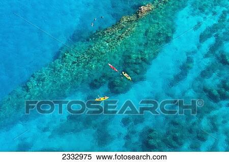 Kayakers and stand up paddleboarders over tropical reef; Makena, Maui, Hawaii, United States of America View Large Photo Image Stock Photography - Kayakers and stand up paddleboarders over tropical reef; Makena, Maui, Hawaii, United States of America. Fotosearch