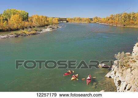 Kayakers on a wide river with trees in autumn colours; Calgary, Alberta, Canada View Large Photo Image Stock Photo - Kayakers on a wide river with trees in autumn colours; Calgary, Alberta, Canada. Fotosearch