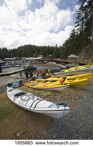 Stock Image - Kayakers Prepare To Go On A Paddling Trip At Telegraph Cove On Vancouver Island; British Columbia, Canada. Fotosearch