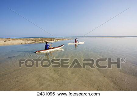 Kayaking along the shoreline of an island in the Indian Ocean; Vamizi Island, Mozambique View Large Photo Image Stock Photograph - Kayaking along the shoreline of an island in the Indian Ocean; Vamizi Island, Mozambique. Fotosearch