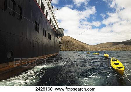 Stock Photo - Kayaks and cruise ship in the Galapagos Islands; Isabela Island, Galapagos Islands, Ecudador. Fotosearch