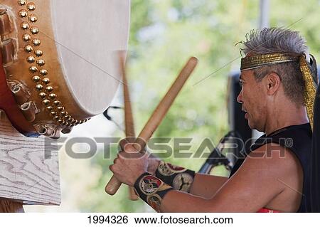 Stock Photograph - Kenny Endo Performing On The Taiko, A Traditional Japanese Drum At The Powell Street Festival In Woodland Park, Vancouver, British Columbia, Canada. Fotosearch
