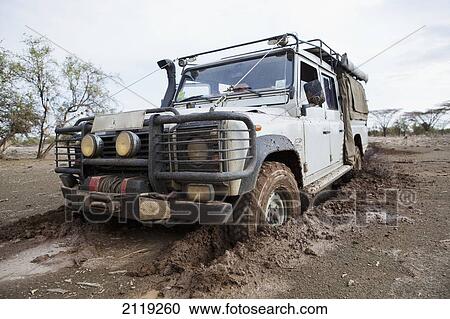 Stock Image - Kenya, Front view of Landrover in mud; North Turkana. Fotosearch
