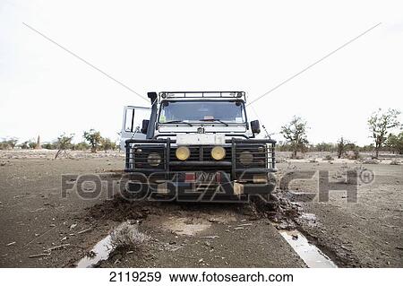 Stock Photo - Kenya, Front view of Landrover in mud; North Turkana. Fotosearch
