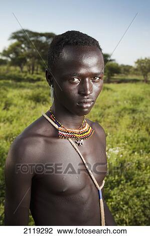 Kenya, Lake Baringo; Rift Valley, Portrait of traditionally dressed man from Pokot tribe View Large Photo Image Stock Image - Kenya, Lake Baringo; Rift Valley, Portrait of traditionally dressed man from Pokot tribe. Fotosearch