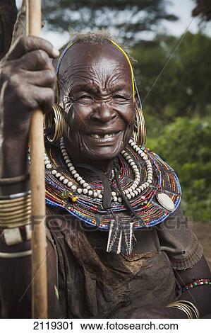Stock Image - Kenya, Lake Baringo; Rift Valley, Portrait of traditionally dressed senior woman from Pokot tribe. Fotosearch
