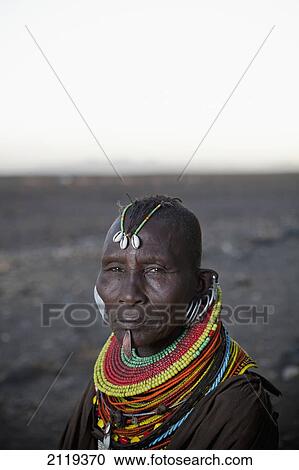 Stock Image - Kenya, Portrait of traditionally dressed Turkana woman on Lake Turkana; Loyangalani. Fotosearch