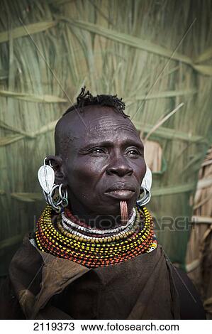 Stock Image - Kenya, Portrait of traditionally dressed Turkana woman on Lake Turkana; Loyangalani. Fotosearch
