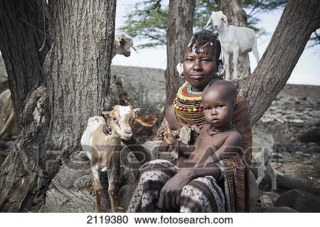 Stock Image - Kenya, Portrait of traditionally dressed Turkana woman and child on Lake Turkana; Loyangalani. Fotosearch