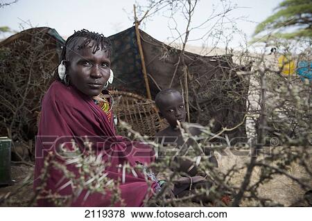 Stock Photo - Kenya, Portrait of traditionally dressed Turkana woman and child on Lake Turkana; Loyangalani. Fotosearch