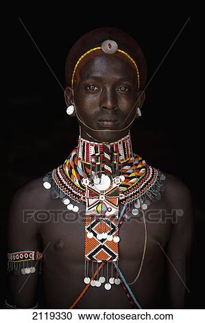 Stock Image - Kenya, Portrait of young Samburu man (Moran) in traditional dress; South Horr. Fotosearch