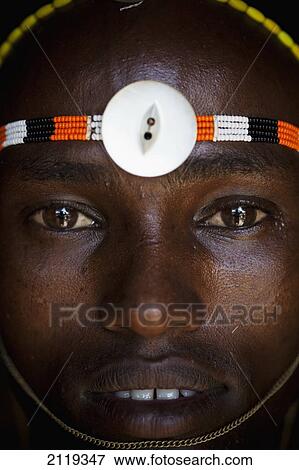 Stock Photo - Kenya, Portrait of young Samburu man (Moran) in traditional dress; South Horr. Fotosearch