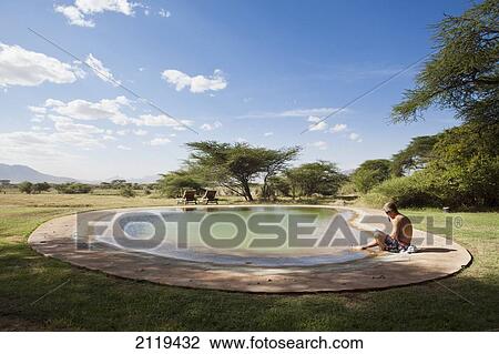 Stock Image - Kenya, Swimming pool at luxurious Joy's Camp; Shaba National Reserve. Fotosearch