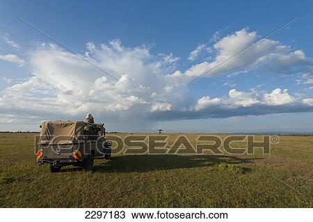 Stock Image - Kenya, Tourist looking at view in Ol Pejeta Conservancy; Laikipia Country. Fotosearch