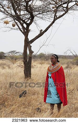 Stock Image - Kenya, Woman dressed in colorful clothing from Samburu Tribe. Fotosearch