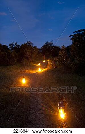 Stock Image - Kerosene lamps lighting path in Ol Pejeta Bush Camp, Ol Pejeta Conservancy; Kenya. Fotosearch