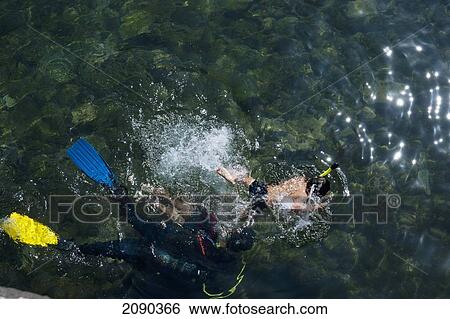 Stock Photograph - Kid Learning How To Dive In Mutriku, Basque Country, Spain. Fotosearch