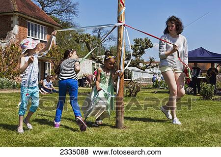 Stock Photo - Kids Dancing Round Maypole; Great Chart, Kent, England, Uk. Fotosearch