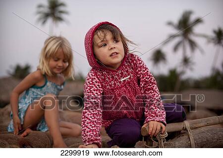 Stock Photo - Kids play together on holiday in India, Patnum Beach, Goa, India.. Fotosearch