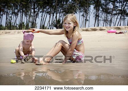 Kids play together on holiday making sandcastles, Turtle Beach, Goa, India. View Large Photo Image Stock Image - Kids play together on holiday making sandcastles, Turtle Beach, Goa, India.. Fotosearch