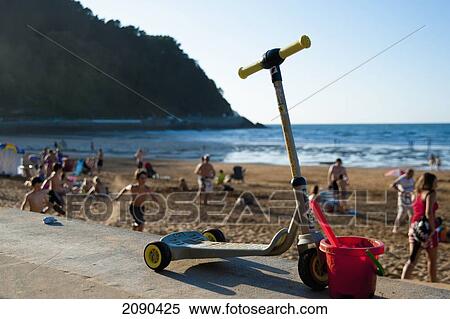 Kids Scooter And Bucket With People At Beach, Zarautz, Basque Country, Spain View Large Photo Image Stock Photography - Kids Scooter And Bucket With People At Beach, Zarautz, Basque Country, Spain. Fotosearch