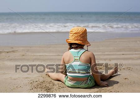 Stock Photograph - Kiki Lett makes sandcastles on holiday in India, Turtle Beach, Goa, India.. Fotosearch