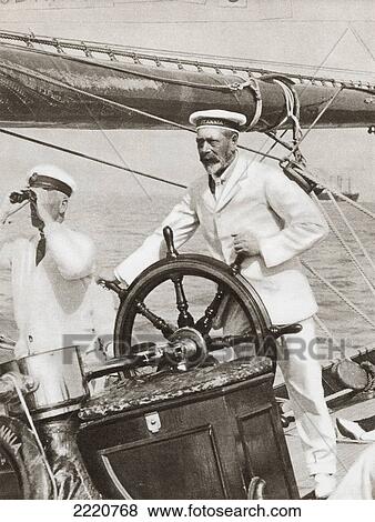 Stock Photo - King George V At The Wheel Of His Yacht, Britannia, During Cowes Regatta Week, England, 1924. From The Story Of 25 Eventful Years In Pictures, Published 1935.. Fotosearch