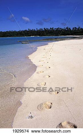 Picture - Kingdom of Tonga, Ha'apai, Footprints in Sand of Clear Blue Water Lagoon; Island of Foa. Fotosearch