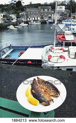Stock Image - Kippers On A Plate On The Quayside In Padstow Harbour. Fotosearch