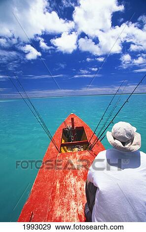Kiribati, Kiritimati (Christmas Island), Bone Fishing From A Red Boat, Man Sits In Front. View Large Photo Image Stock Photo - Kiribati, Kiritimati (Christmas Island), Bone Fishing From A Red Boat, Man Sits In Front.. Fotosearch