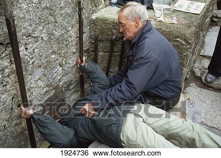 Stock Photograph - Kissing The Blarney Stone. Fotosearch