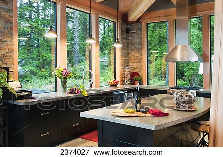 Stock Photo - Kitchen Of Ocean-Side Home Features Views Of The Open Water; Port Renfrew, Vancouver Island, British Columbia, Canada. Fotosearch