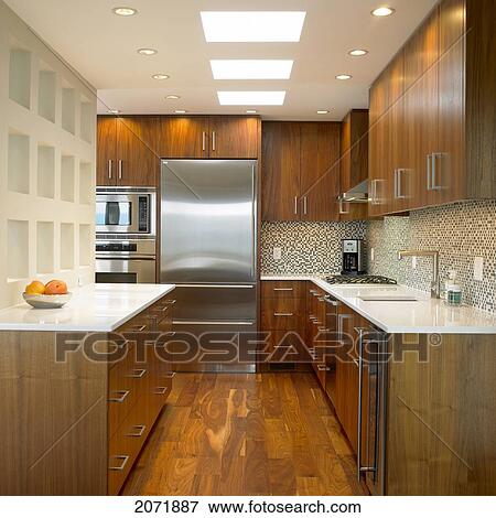 Kitchen With Walnut Cabinets And Corian Countertops Stock Photo