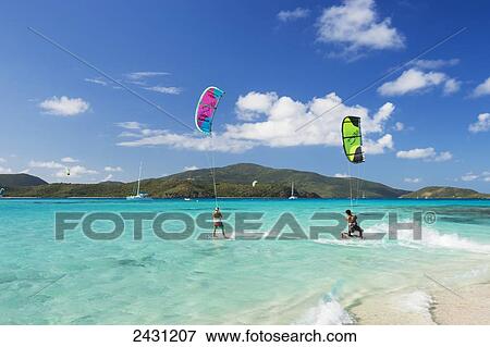 Kiteboarders riding over the crystal blue waters; Necker Island, British Virgin Islands View Large Photo Image Stock Photo - Kiteboarders riding over the crystal blue waters; Necker Island, British Virgin Islands. Fotosearch