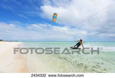Stock Image - Kiteboarding in tropical lagoon in the South Pacific; Tikehau, French Polynesia. Fotosearch