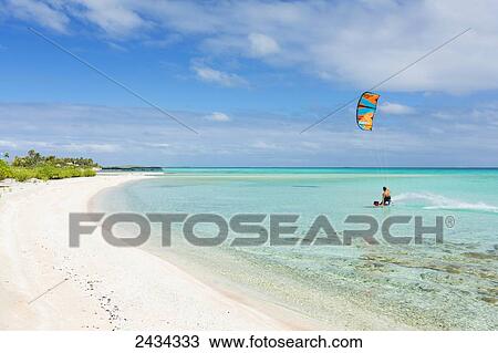 Stock Image - Kiteboarding in tropical lagoon in the South Pacific; Tikehau, French Polynesia. Fotosearch