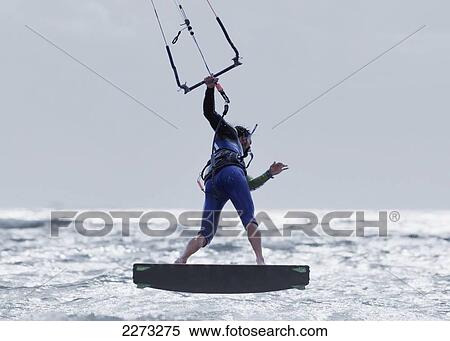 Kitesurfer balancing on a board on the water; tarifa cadiz andalusia spain View Large Photo Image Stock Photography - Kitesurfer balancing on a board on the water; tarifa cadiz andalusia spain. Fotosearch