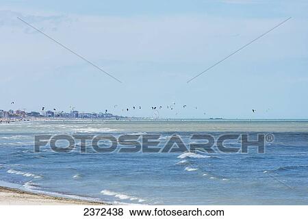 Stock Photo - Kitesurfing In The Distance Along The Coastline; Rimini, Emilia-Romagna, Italy. Fotosearch