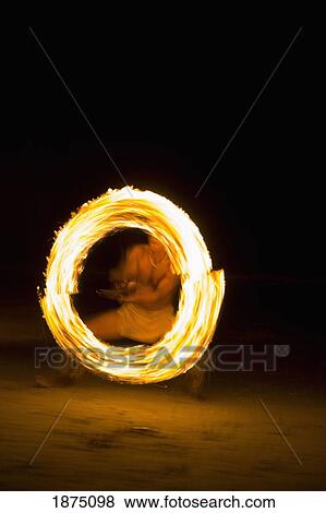 Stock Photo - Koh Chang, Thailand; A Fire Eater Displaying Fire. Fotosearch