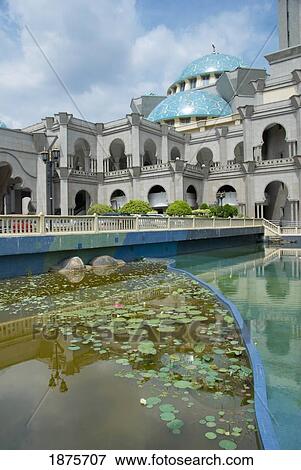 Stock Photo - Kuala Lumpur, Malaysia; A Building With Archways, A Blue Dome Roof And Water Around It. Fotosearch