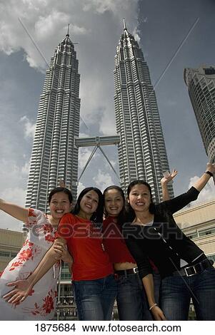 Kuala Lumpur, Malaysia; Four Young Women Posing In Front Of The Petronas Towers View Large Photo Image Picture - Kuala Lumpur, Malaysia; Four Young Women Posing In Front Of The Petronas Towers. Fotosearch