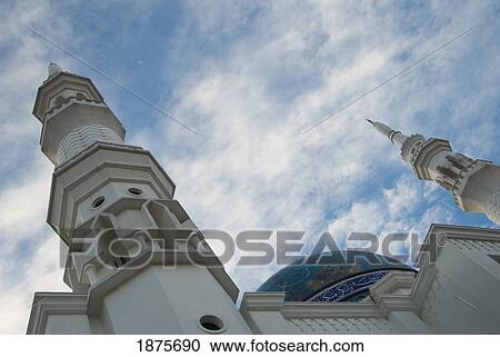 Stock Image - Kuala Lumpur, Malaysia; Two Towers With Ornate Facade And A Blue Domed Roof. Fotosearch