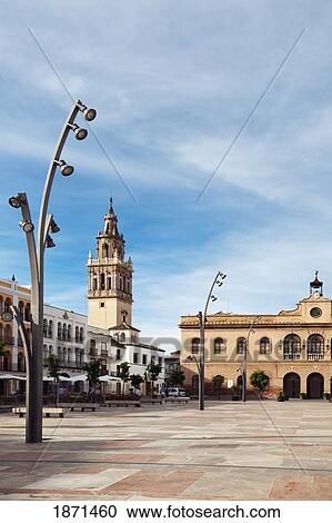La Plaza De España With The Town Hall And The Tower Of The Iglesia De Santa Maria In Background; Ecija, Sevilla, Spain View Large Photo Image Stock Image - La Plaza De España With The Town Hall And The Tower Of The Iglesia De Santa Maria In Background; Ecija, Sevilla, Spain. Fotosearch